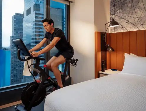 Hilton and Peloton Elevate Wellness Travel Through In?Room Fitness Experience