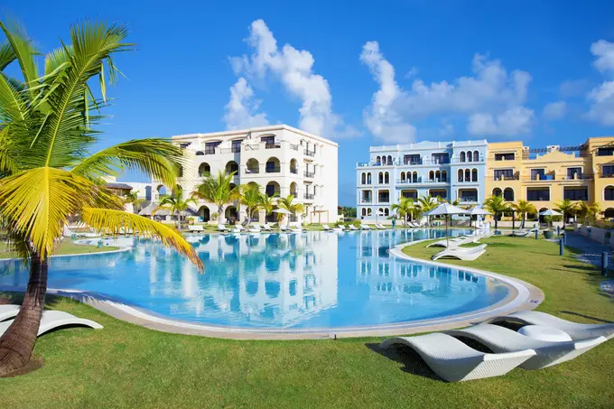 Swimming pool by the luxury resort hotel buildings: Image by Kaspars Grinvalds
